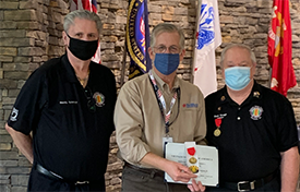 Dave McIntyre presented the National Achievement Medal and challenge coin from members of VVA