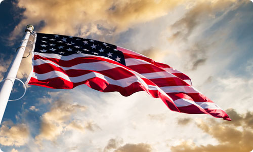 American flag with dramatic sky